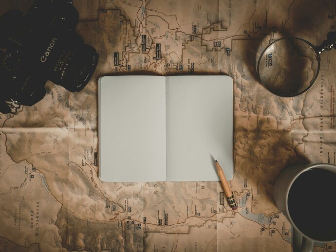 A notebook lying open with a pencil on the blank page
