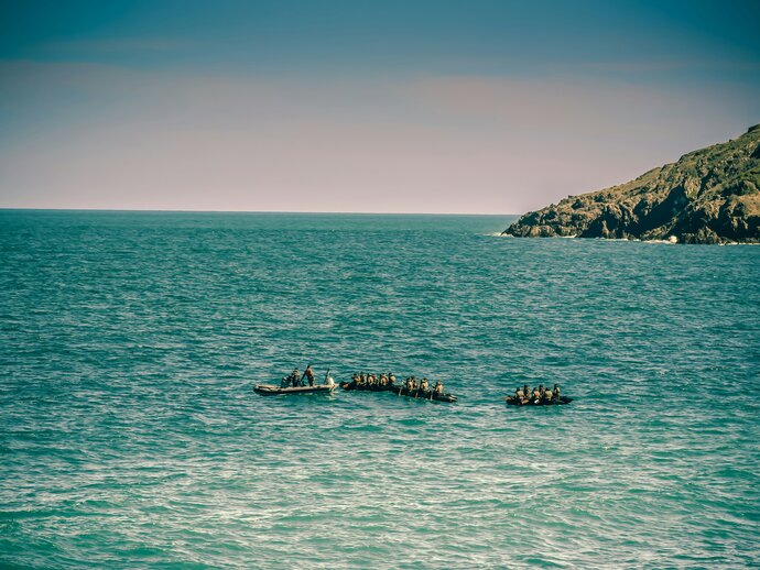 A zoomed out image of crowded boats on the ocean 