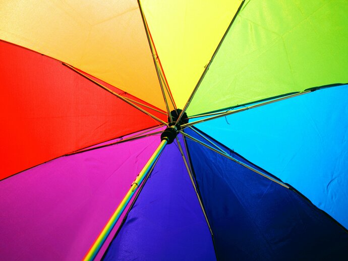 A rainbow umbrella photographed from below