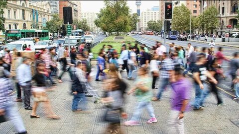 time lapse blurred photo of people walking around a busy pedestrianised square